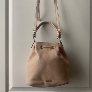 COPY - Nine West faux leather crossbody drawstring bag in a blush color with tw…
